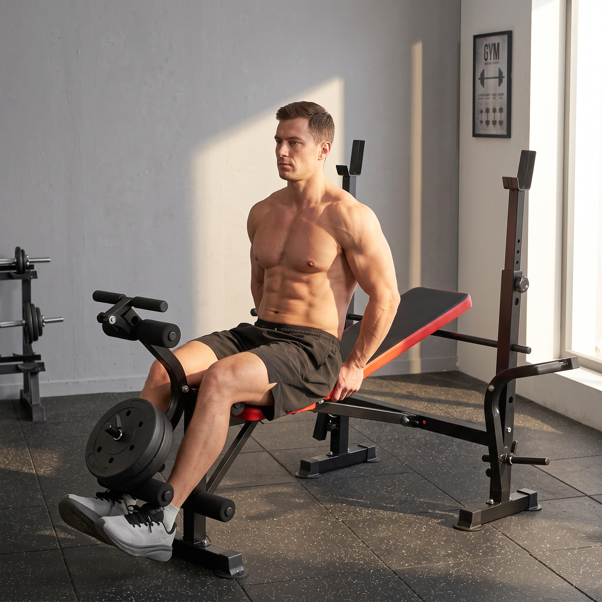 Un hombre musculoso y sin camisa se sienta en un banco de pesas con extensión de piernas en un gimnasio.