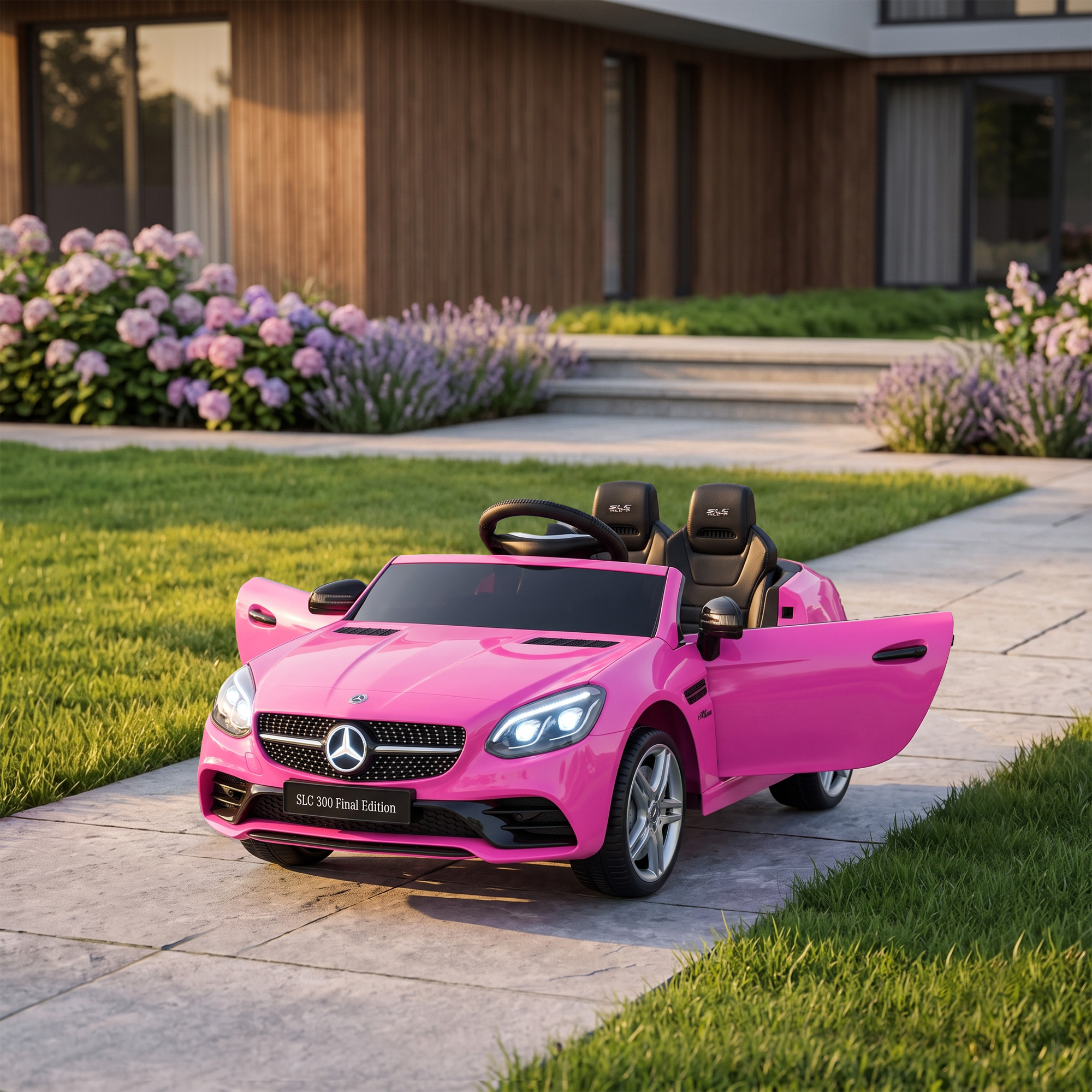 Un coche de juguete descapotable rosa con las puertas abiertas se encuentra en un camino pavimentado.