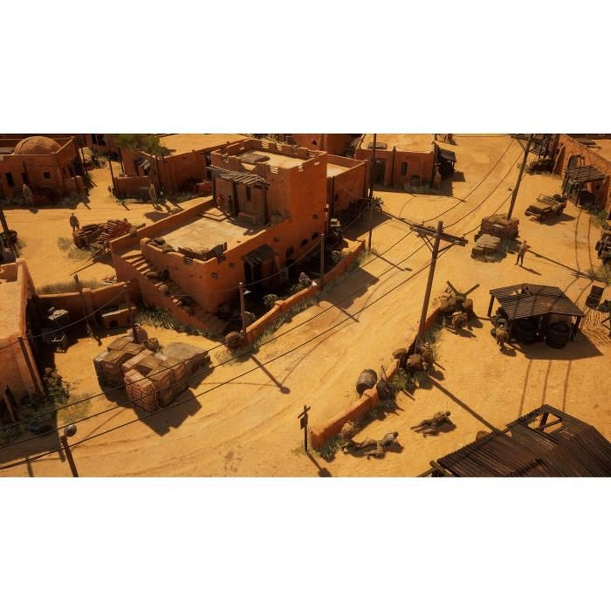 Vista dall'alto di una città nel deserto con edifici in mattoni di terra, strade polverose e pali.