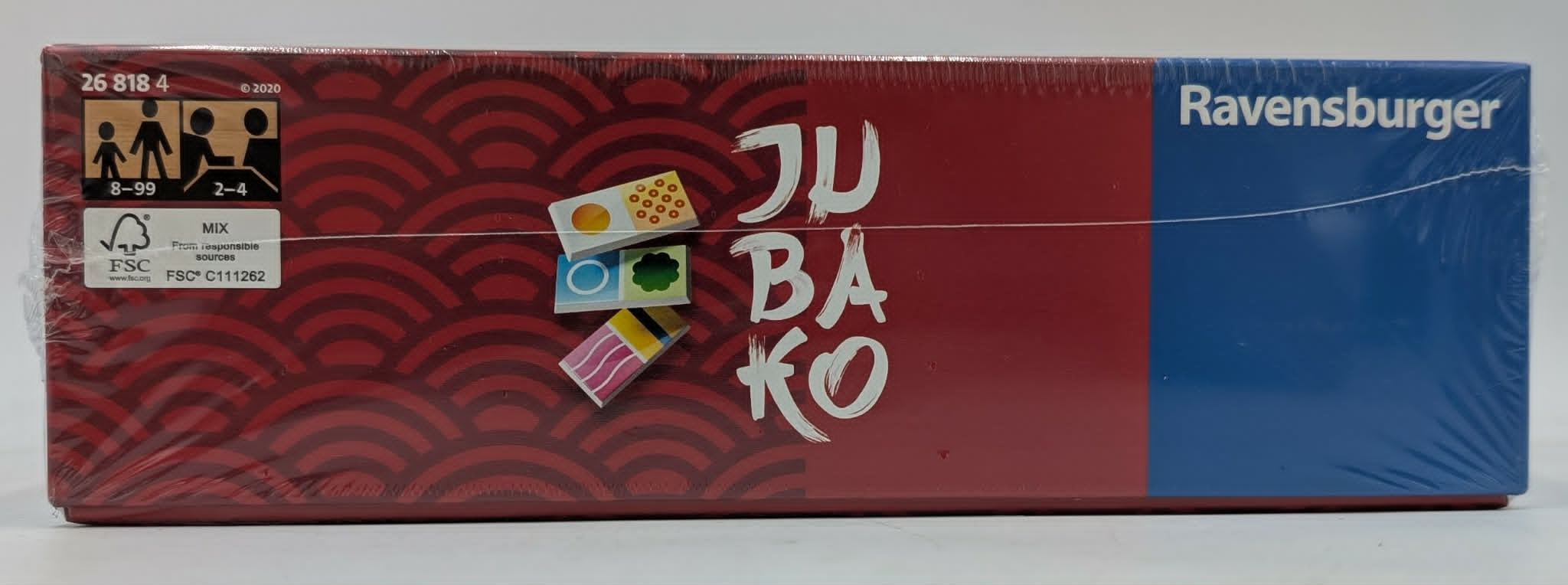 Seitenansicht der Ravensburger Jubaiko Brettspielschachtel mit rotem Wellenmuster.