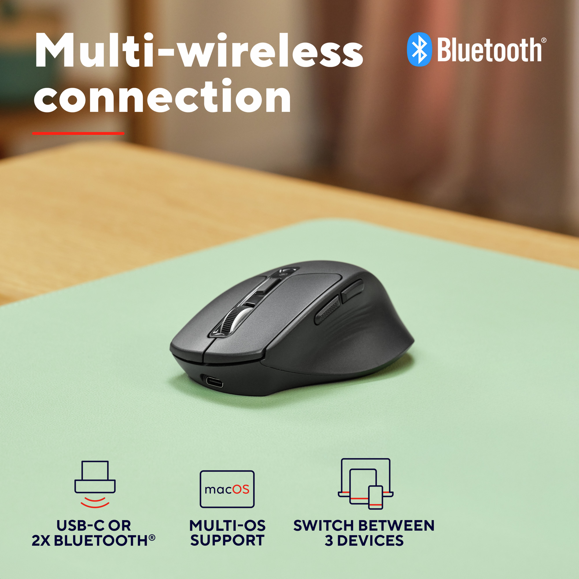 Eine graue kabellose Maus auf einem grünen Mauspad mit Bluetooth-Symbol und Text.