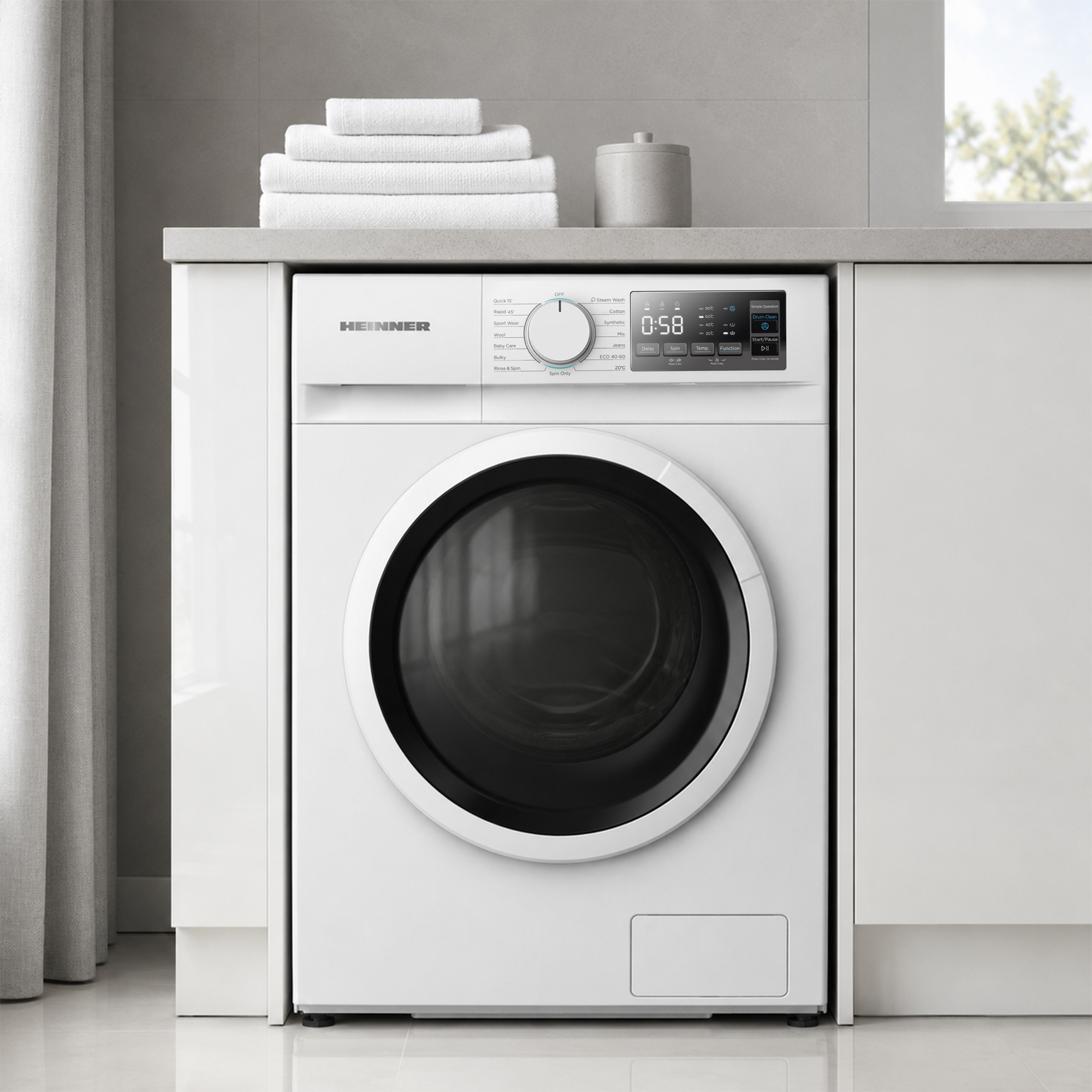 Un lave-linge blanc sous un comptoir avec des serviettes empilées.