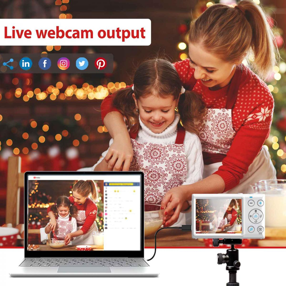 Mutter und Tochter backen vor einem Weihnachtsbaum, verbunden mit Laptop und Kamera für Live-Übertragung.