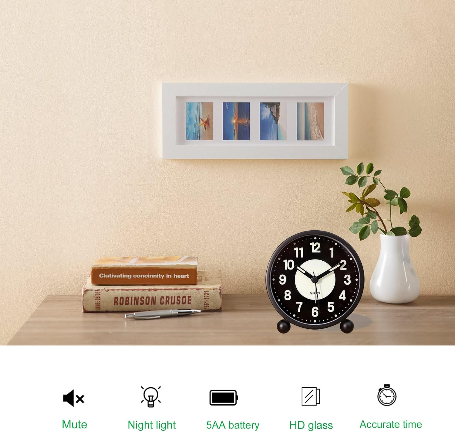 Ein schwarzer Wecker, zwei Bücher, ein Stift, eine weiße Vase mit Pflanze und ein gerahmtes Foto an einer Wand.