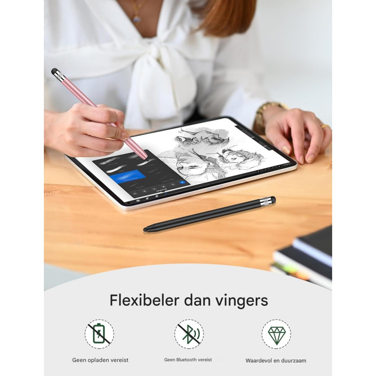 Eine Person zeichnet mit einem rosa Eingabestift auf ein Tablet, während ein schwarzer Stift auf dem Tisch liegt.