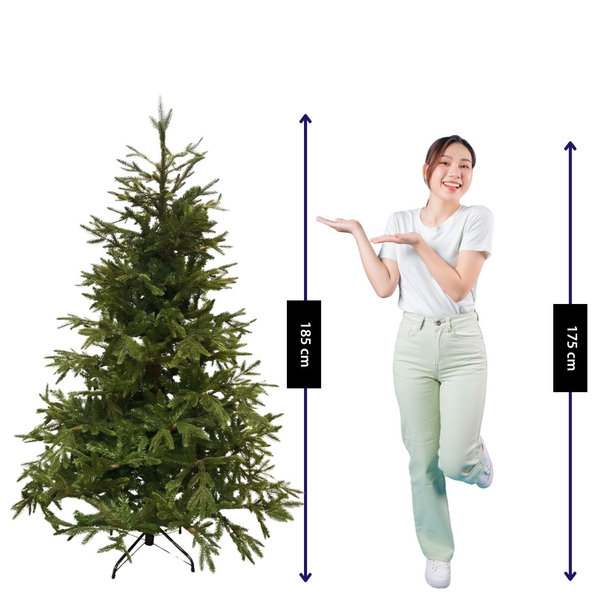 A smiling woman presents a 185 cm tall artificial Christmas tree.