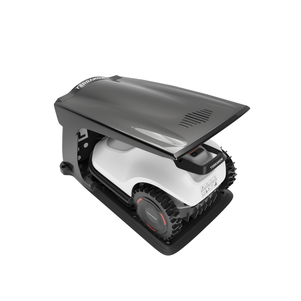Un robot tondeuse blanc et noir repose dans une station de charge noire sur fond blanc.