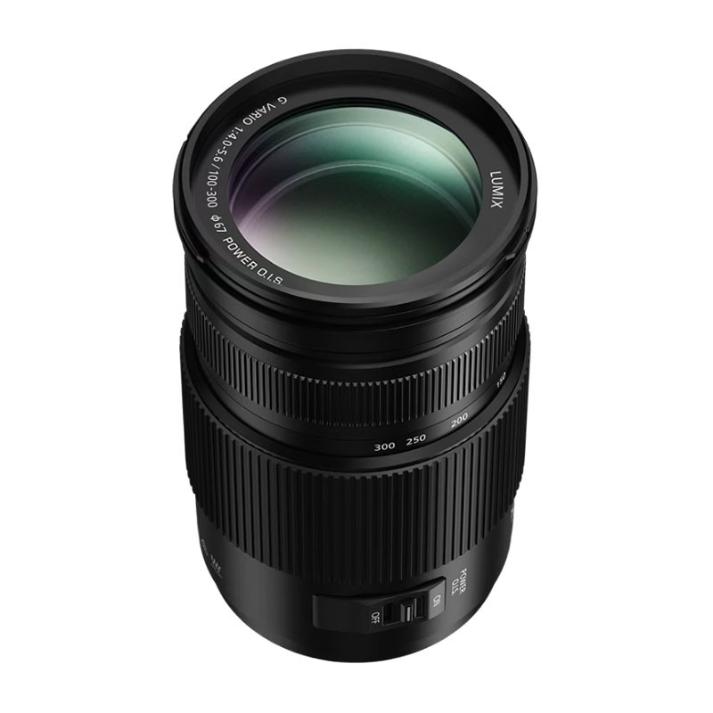 Ansicht von oben auf ein schwarzes Panasonic Lumix G Vario 100-300mm Kameraobjektiv vor weißem Hintergrund.