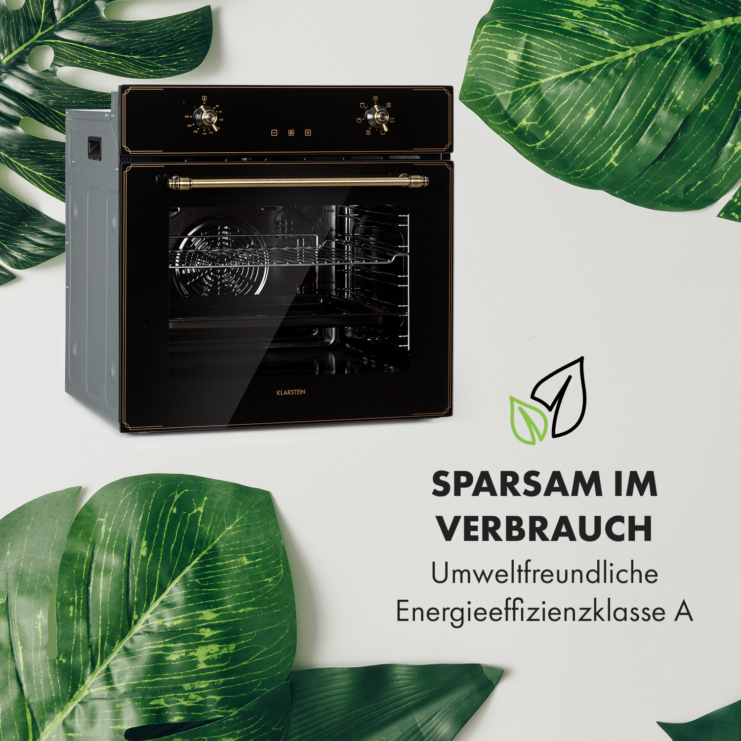 Un forno nero con dettagli dorati è circondato da foglie di palma verdi.