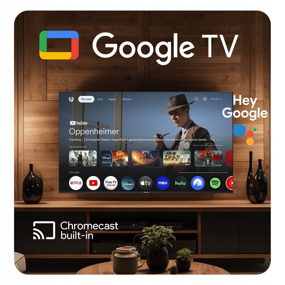 Interfejs Google TV wyświetlany na telewizorze z płaskim ekranem na tle drewnianej ściany.