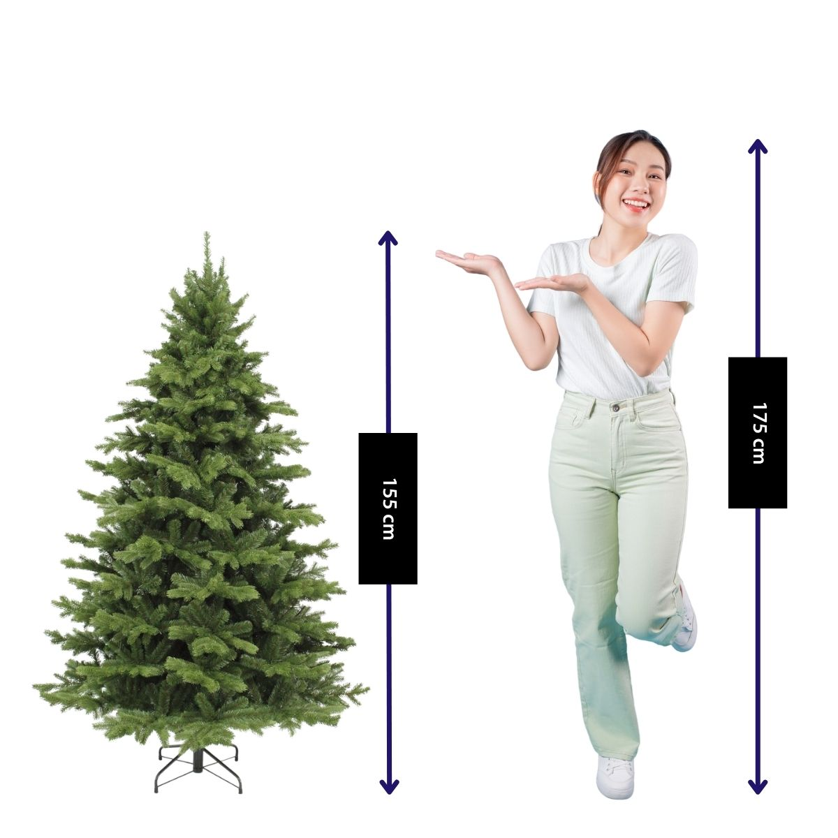 A woman in a white shirt and light pants poses next to a 155 cm tall artificial Christmas tree.
