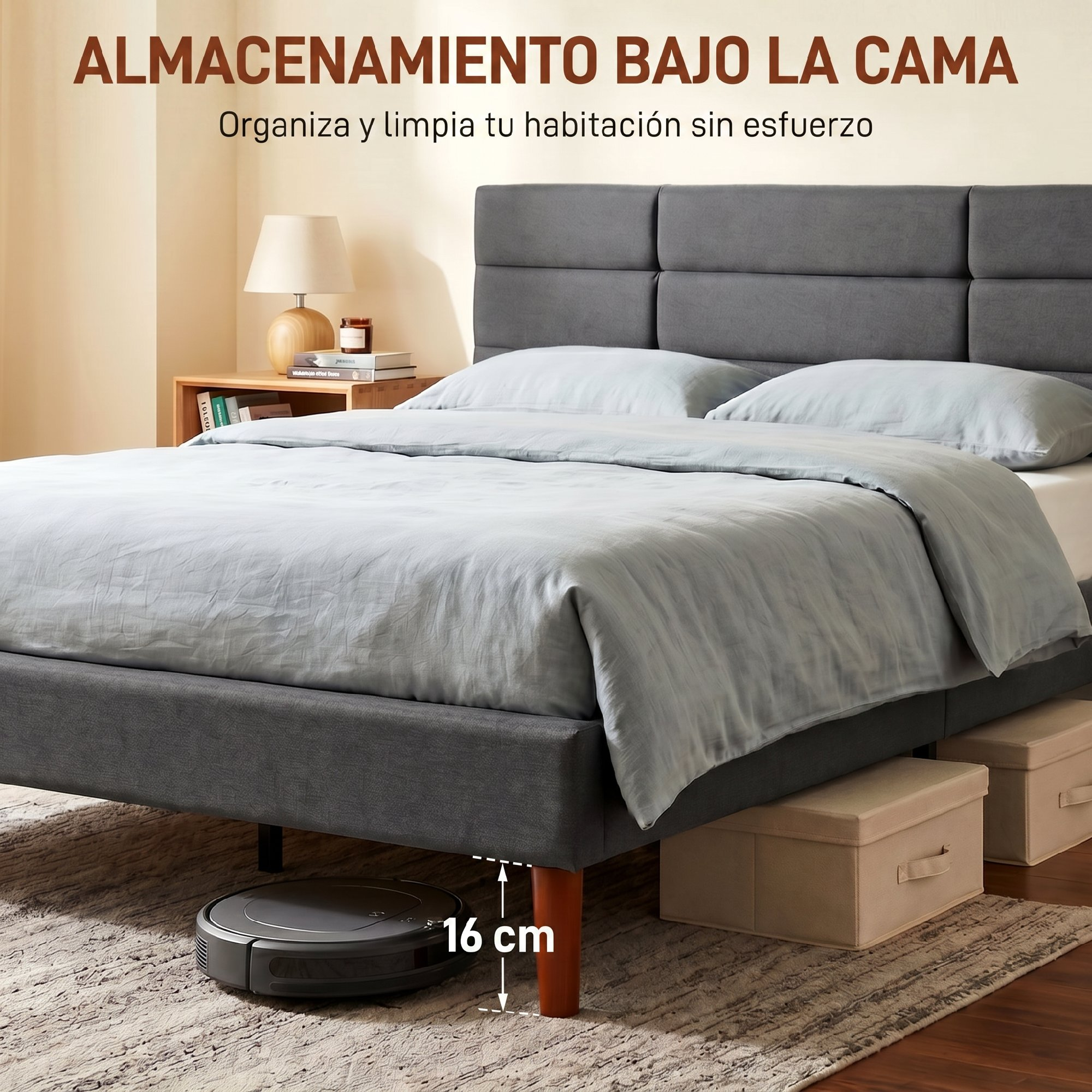 Cama doble gris con almacenamiento y robot aspirador debajo sobre alfombra.