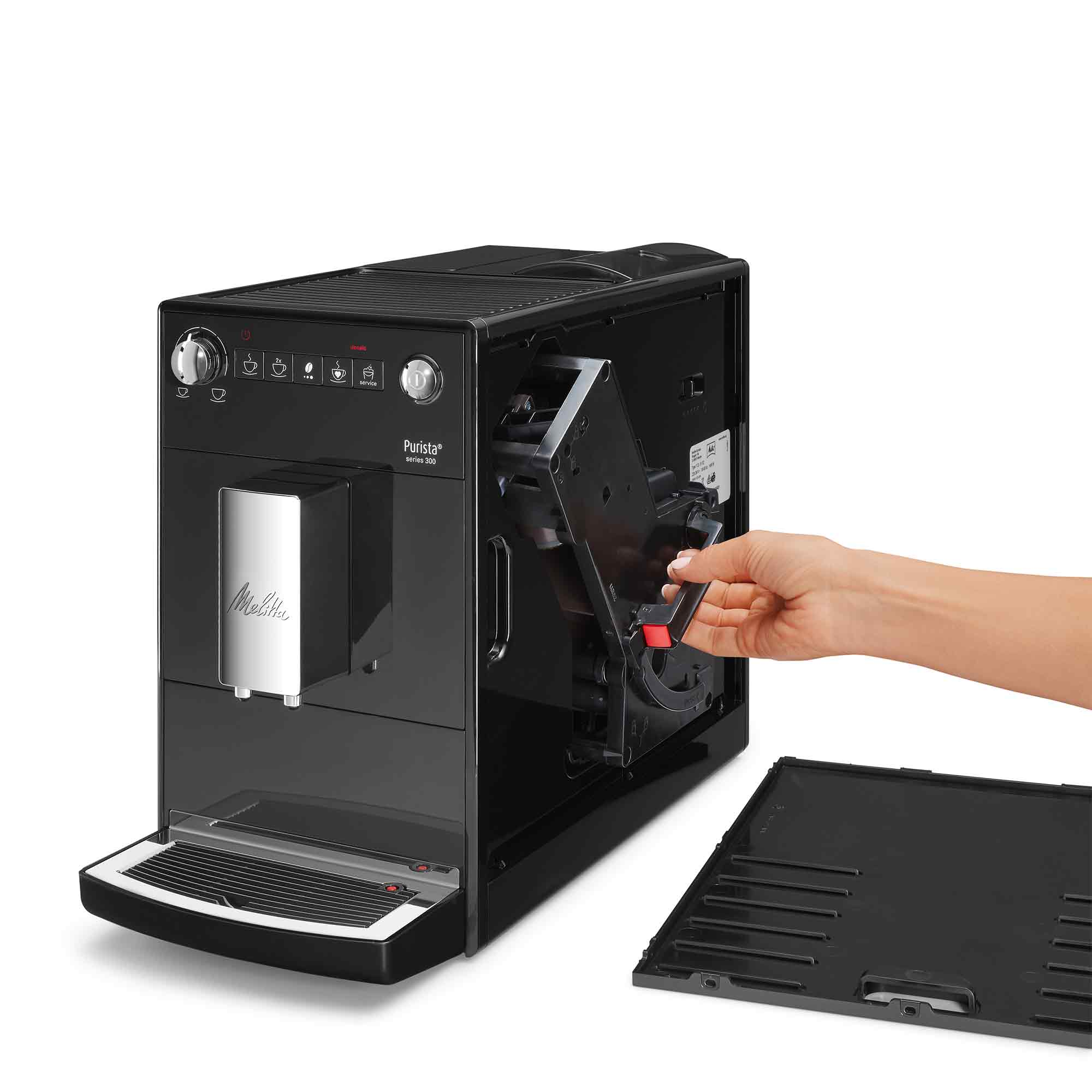 Una mano estrae l'unità erogatrice da una macchina da caffè Melitta nera.