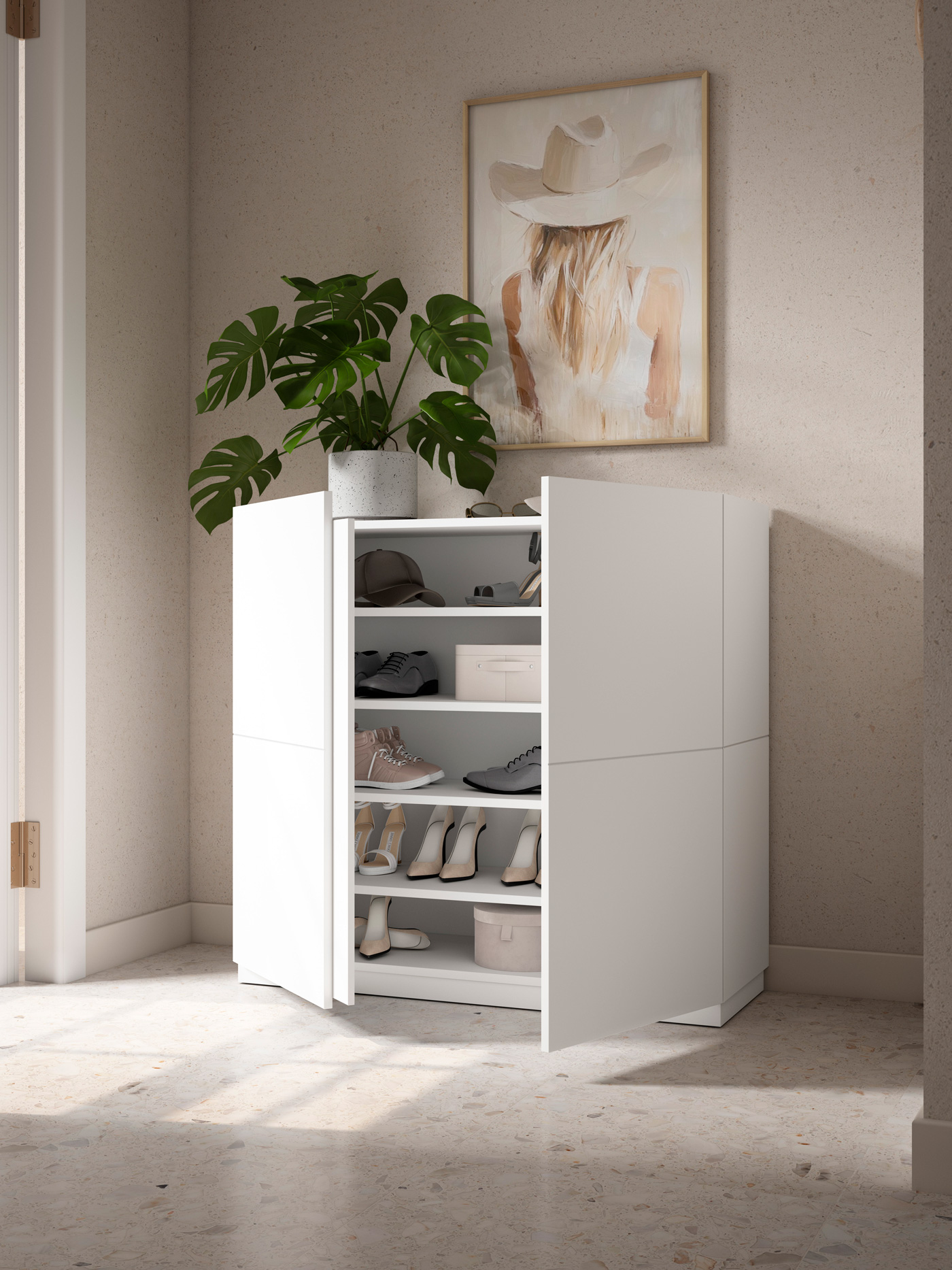 Un zapatero blanco con puertas abiertas muestra zapatos, una planta encima y un cuadro en la pared.