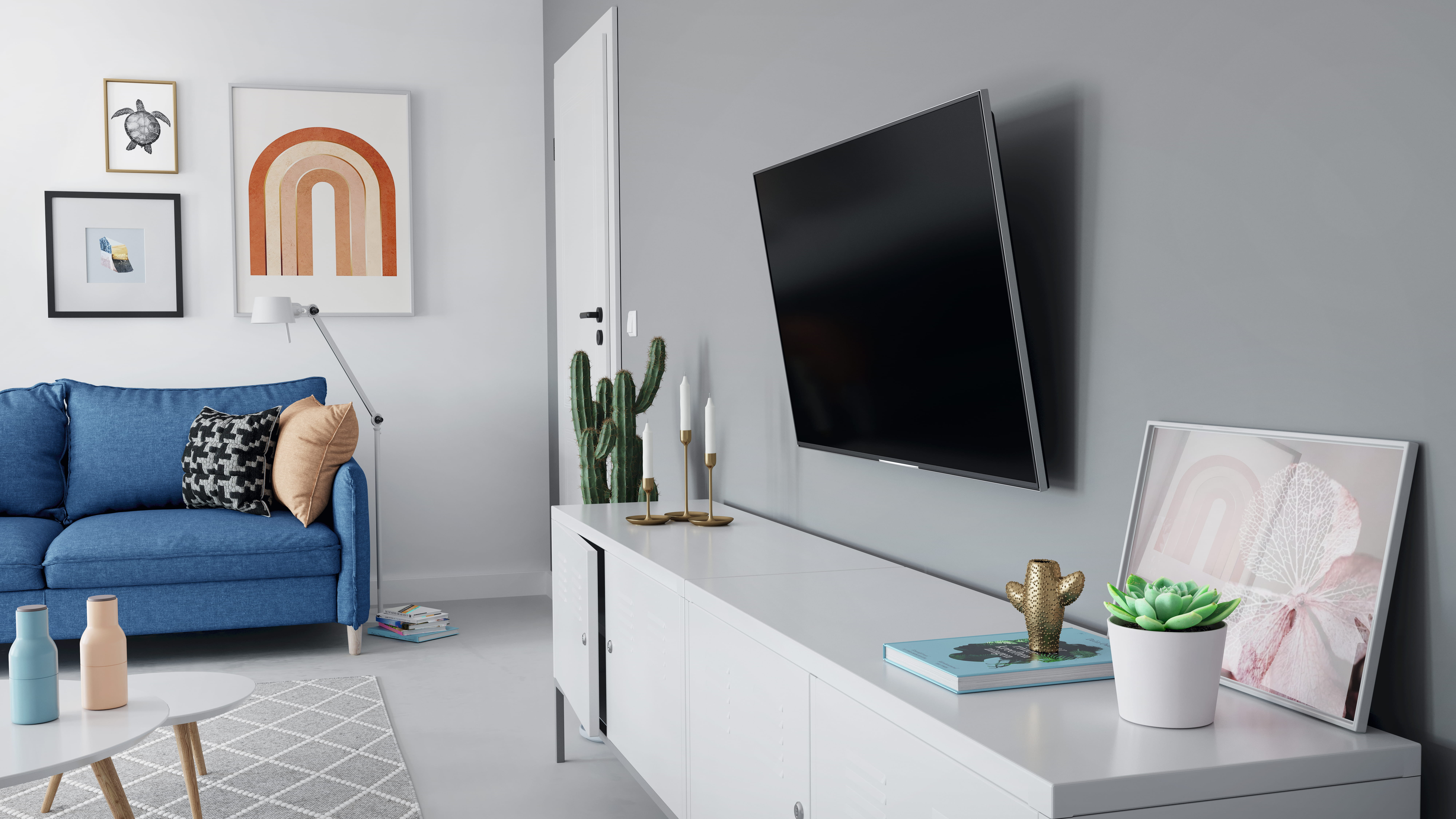 Wohnzimmer mit blauem Sofa, weißem Fernsehmöbel, Wandfernseher und Dekor