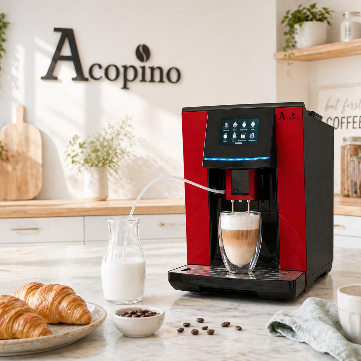 Rote Acopino Kaffeemaschine auf Marmortheke, daneben Milchkaraffe, Croissants und Kaffeebohnen in heller Küche.