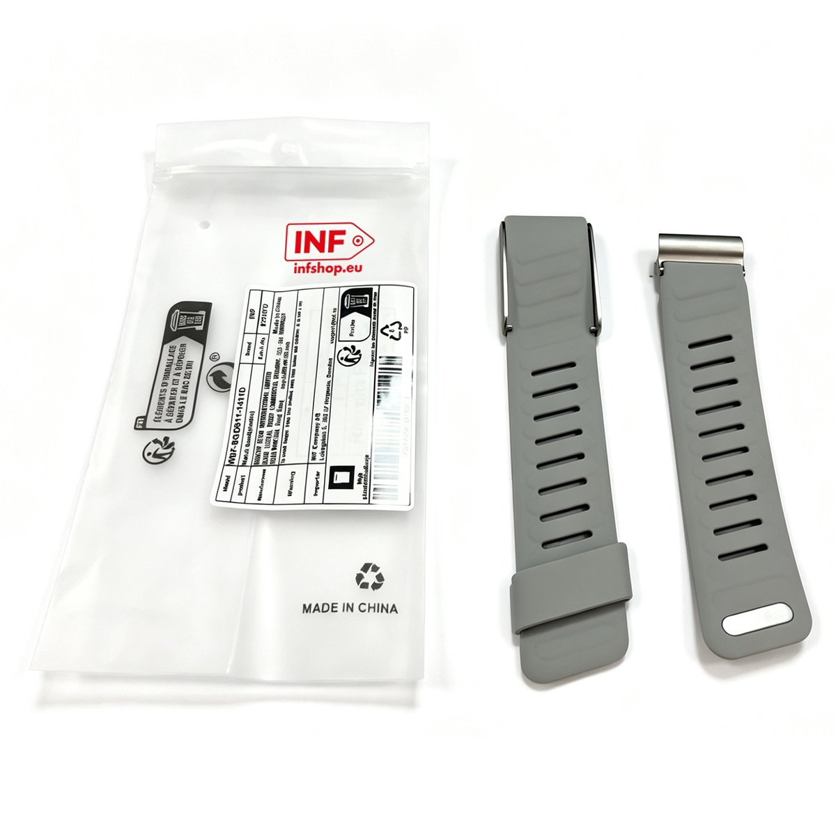 Graues Silikon-Uhrenarmband mit Schlitzen nebengelegt zu einer Kunststoffverpackung.