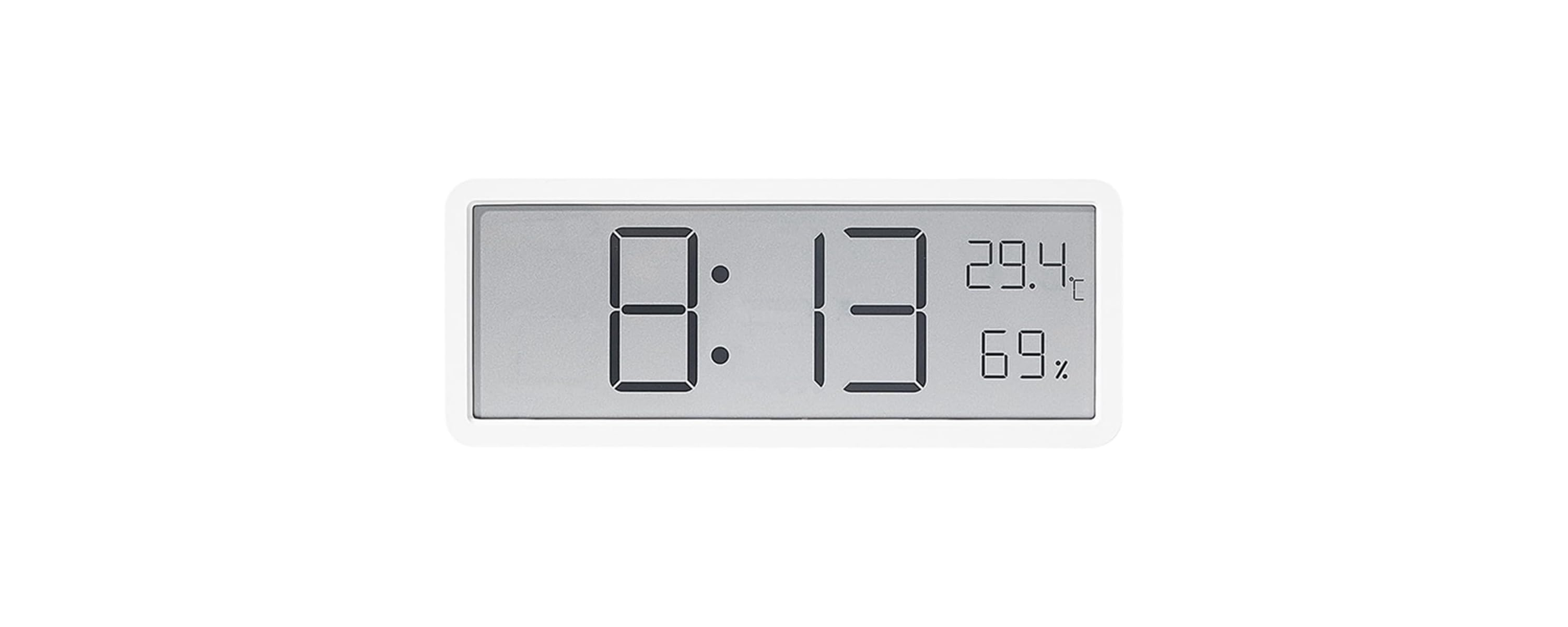 Eine weiße Digitaluhr zeigt auf einem grauen Bildschirm 8:13 Uhr, 29,4 Grad Celsius und 69% Luftfeuchtigkeit an.