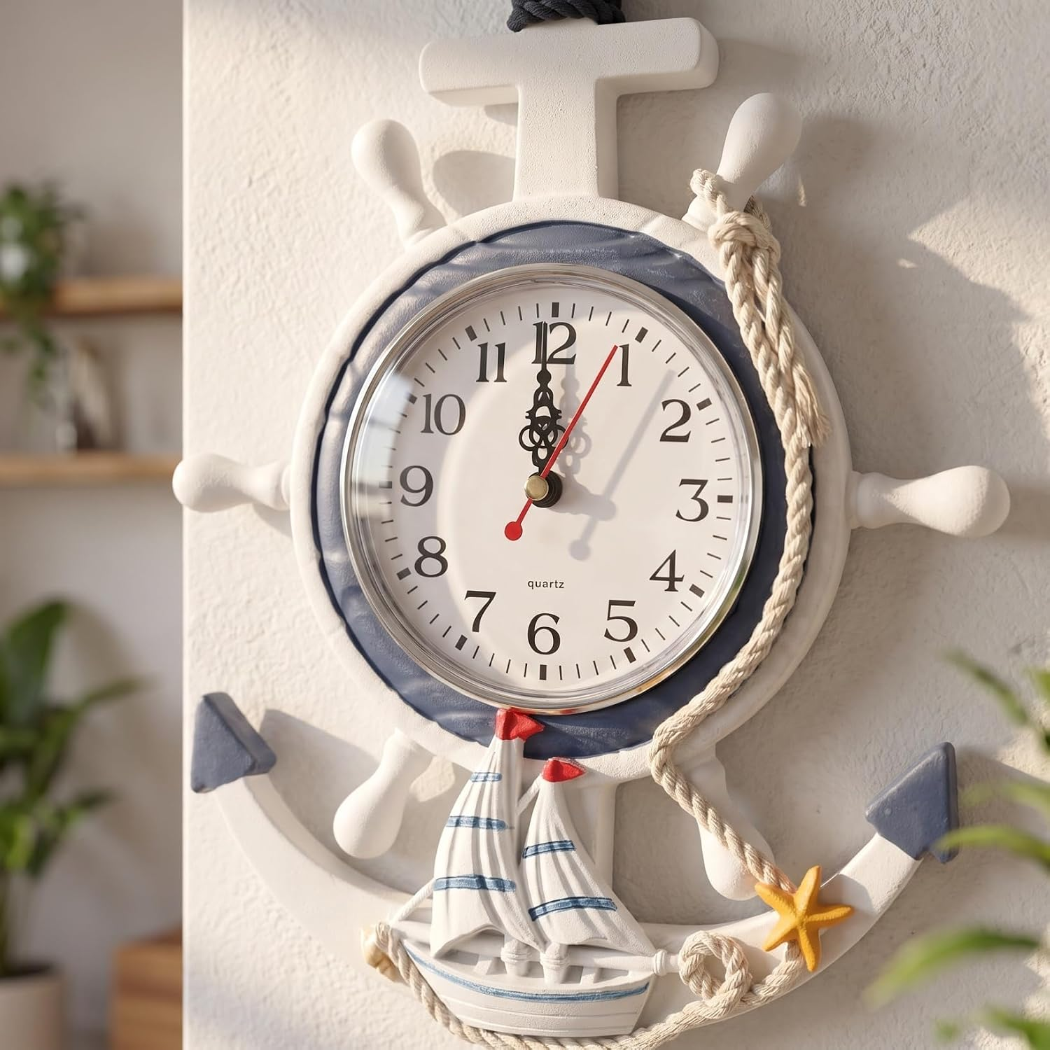 Eine maritime Wanduhr im Design von Steuerrad und Anker, verziert mit Segelboot, Tau und Seestern.