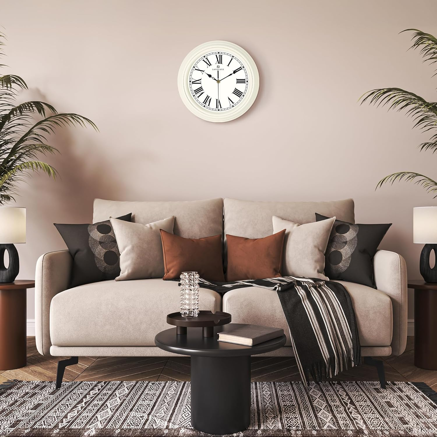 Ein beiges Sofa mit Kissen, ein schwarzer Couchtisch, Lampen auf Beistelltischen, eine Wanduhr und Topfpflanzen.