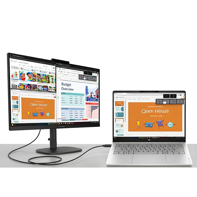 A laptop is connected by cable to a large external monitor displaying a budget overview.