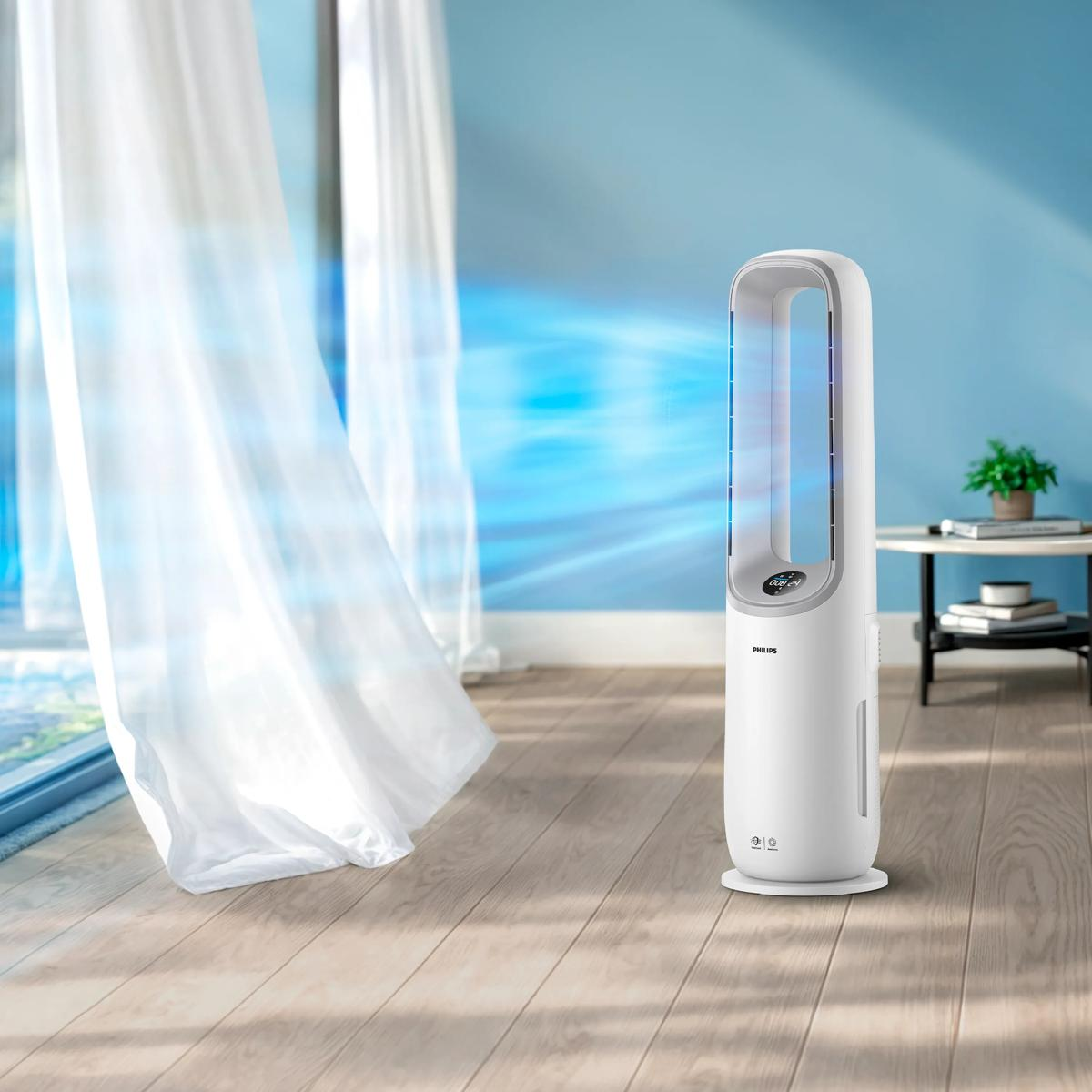Ein weißer Philips Turmventilator auf Holzboden, blauer Luftstrom bläst zu Vorhängen.