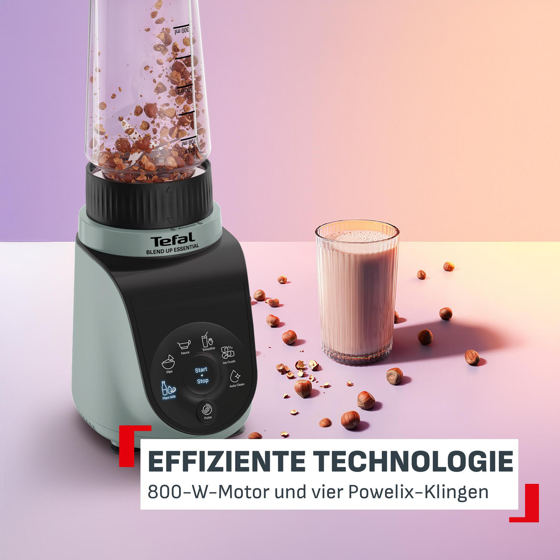 Un frullatore Tefal frulla nocciole accanto a un bicchiere di latte di nocciole su sfondo sfumato.