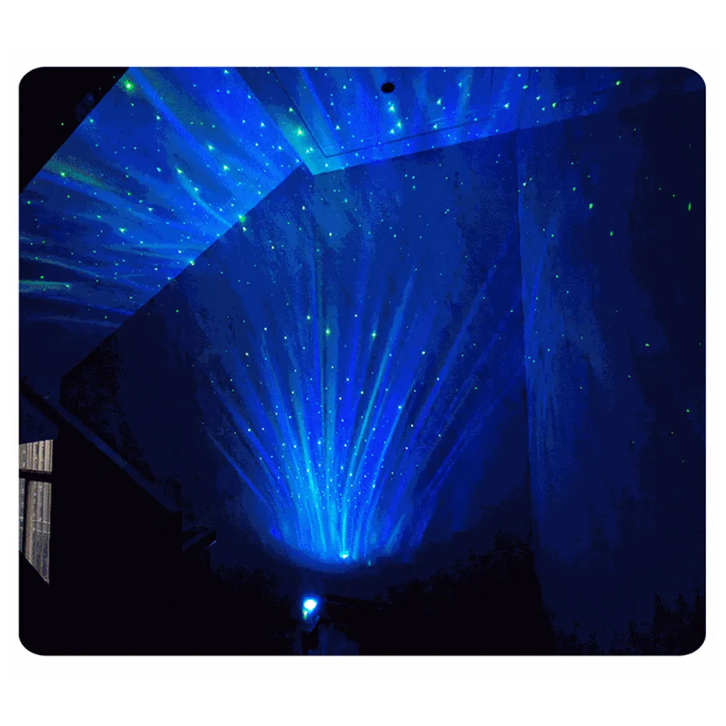 Eine Zimmerdecke beleuchtet mit blauen Laserlichtern und grün leuchtenden Sternen wie ein Sternenhimmel.