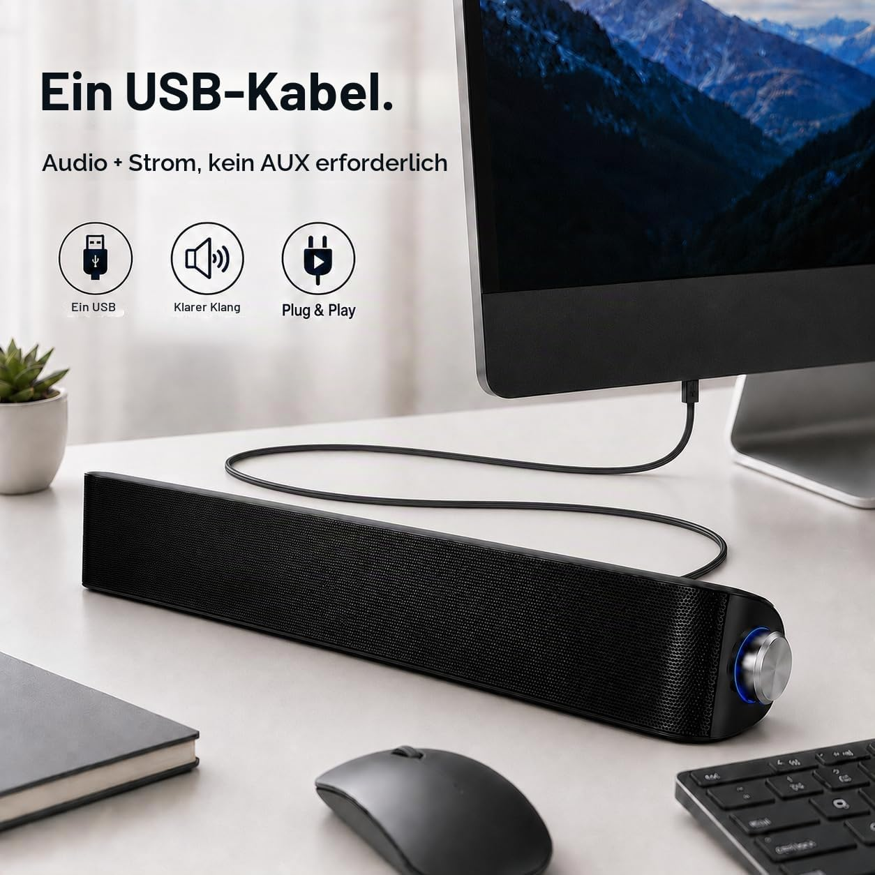 Eine schwarze USB-Soundbar auf einem Schreibtisch vor einem Monitor mit deutscher Textüberlagerung.