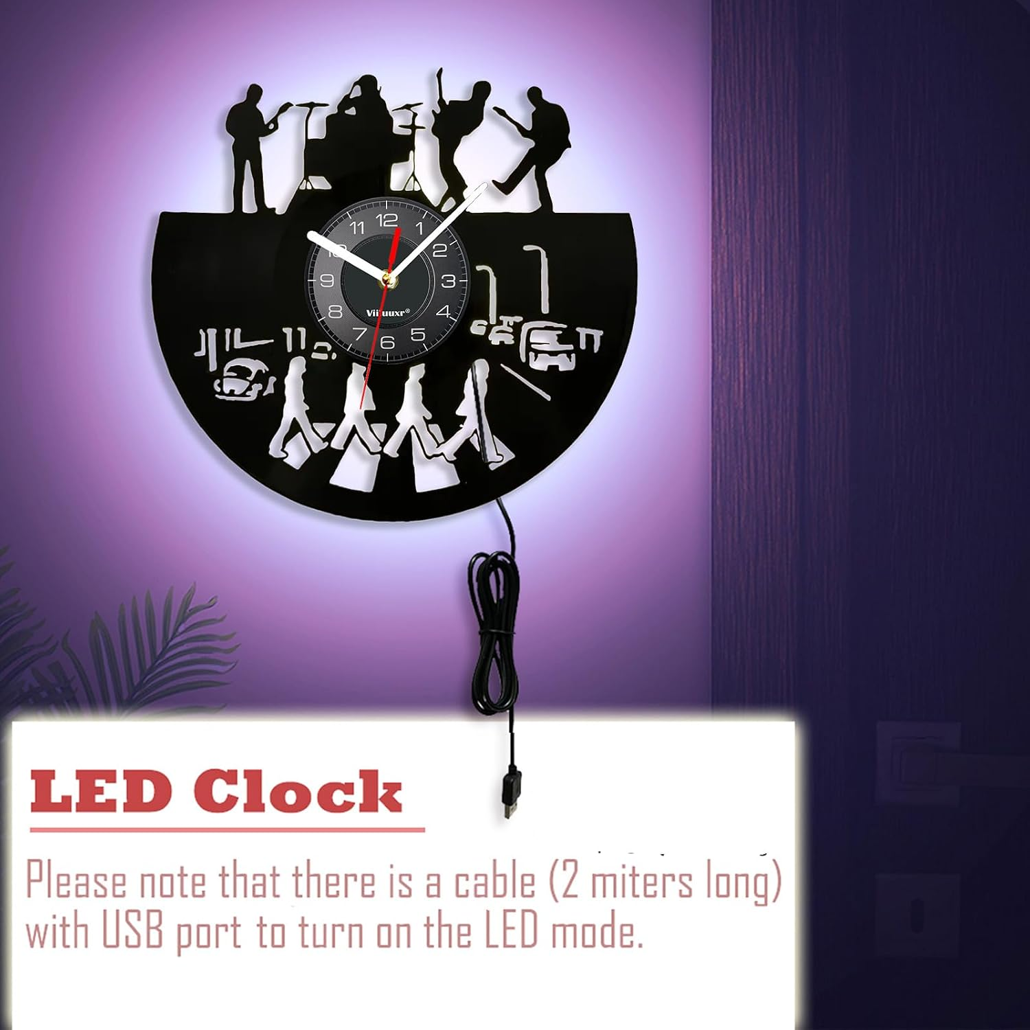 Eine kunstvolle Wanduhr aus einer Schallplatte mit Band-Silhouetten, Abbey Road Motiv und USB-Kabel.