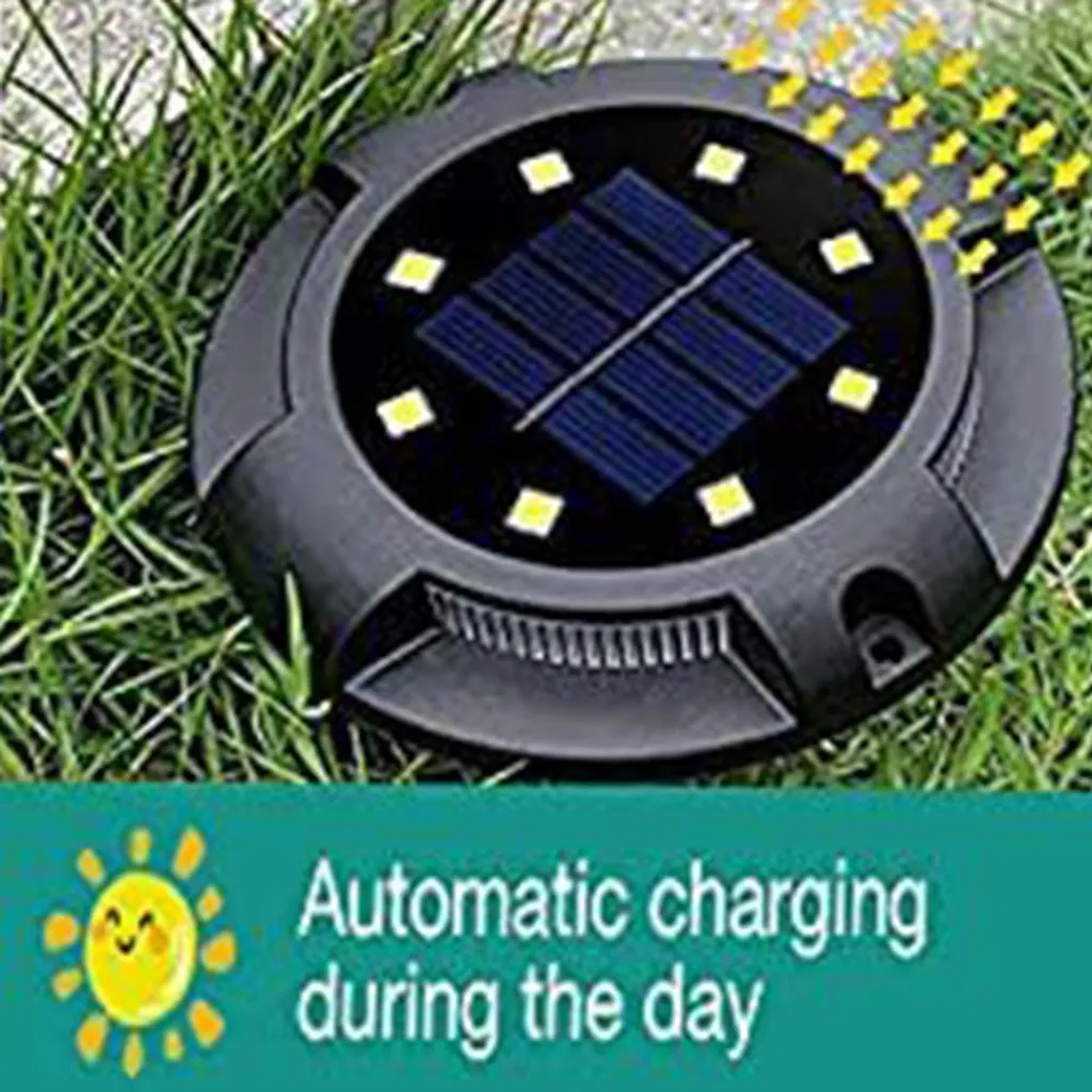 Runde schwarze Solarlampe im Gras mit LEDs und Solarpanel.