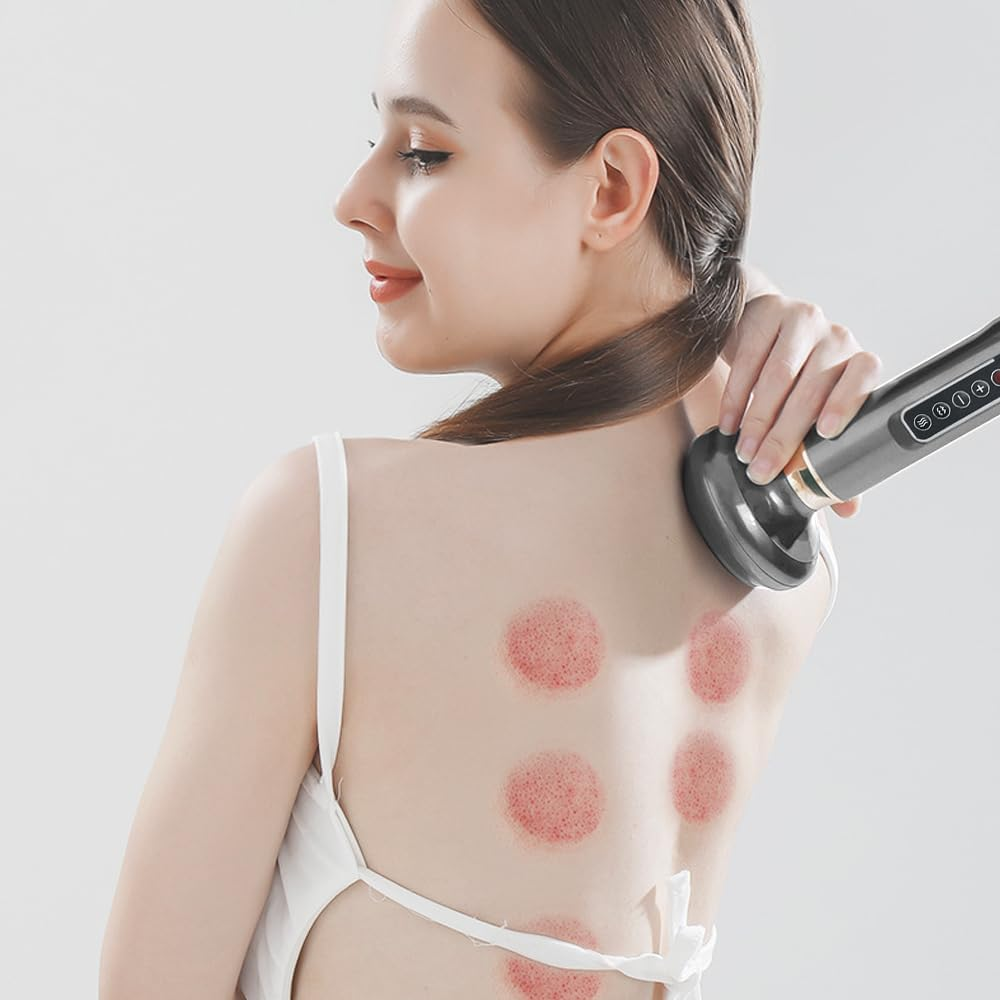 Eine Frau in weißer Kleidung verwendet ein graues Massagegerät an ihrem Rücken mit roten runden Flecken.