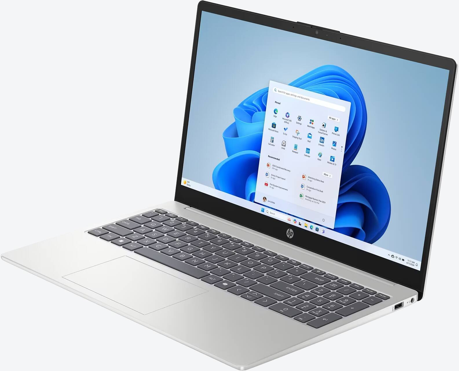 Srebrny laptop z czarną klawiaturą i menu Start systemu Windows 11 na ekranie, na białym tle.
