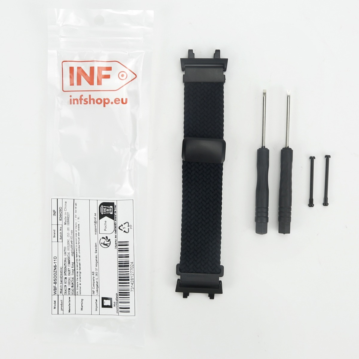 Ein schwarzes Nylon-Uhrenarmband, zwei Werkzeuge und zwei Stifte neben einer Marken-Verpackung.