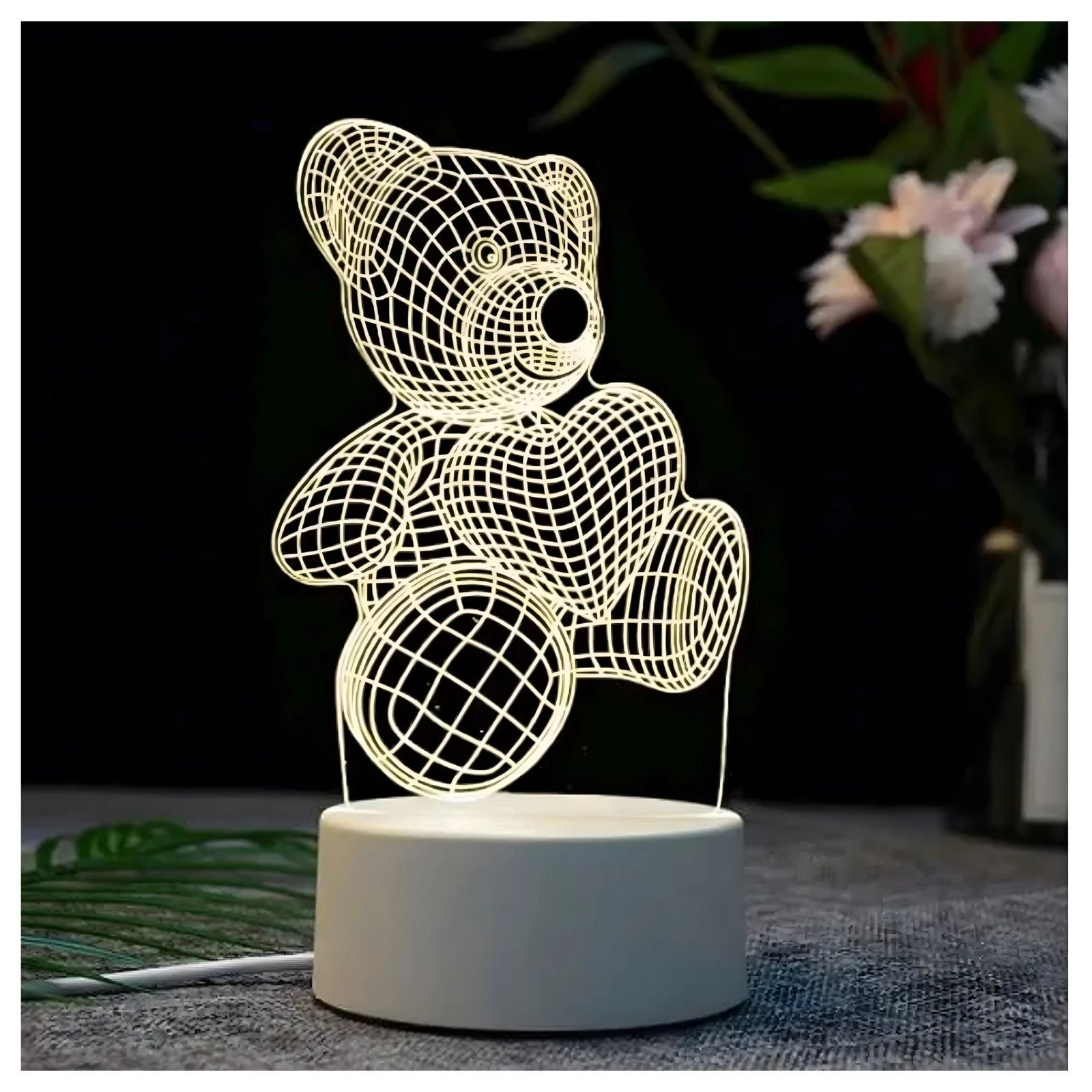 Świetlna lampka 3D z misiem na okrąg łej podstawie na ciemnym tle.