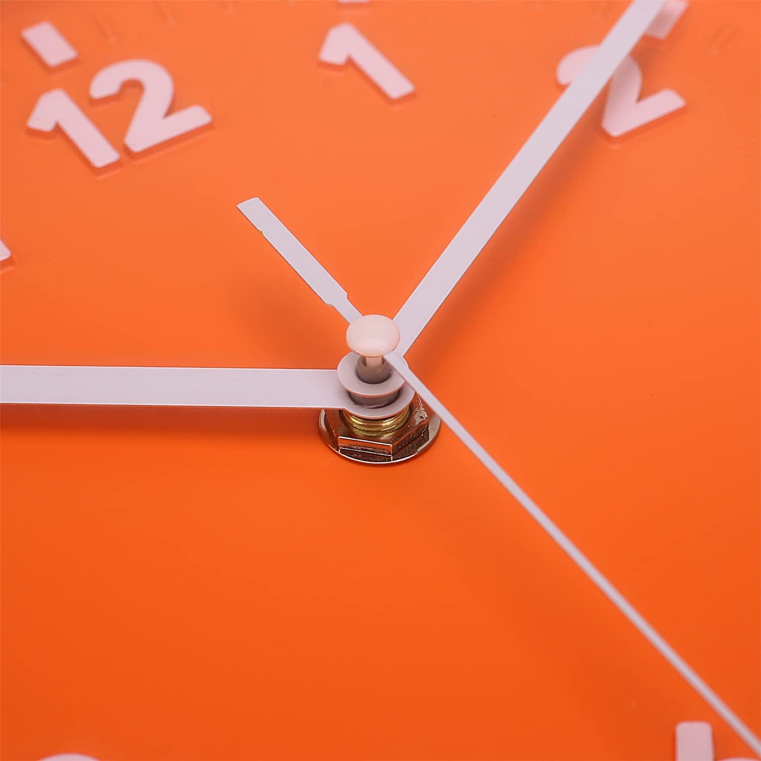 Nahaufnahme eines orangen Zifferblatts mit weißen Zeigern und den Zahlen 11, 12, 1 und 2.