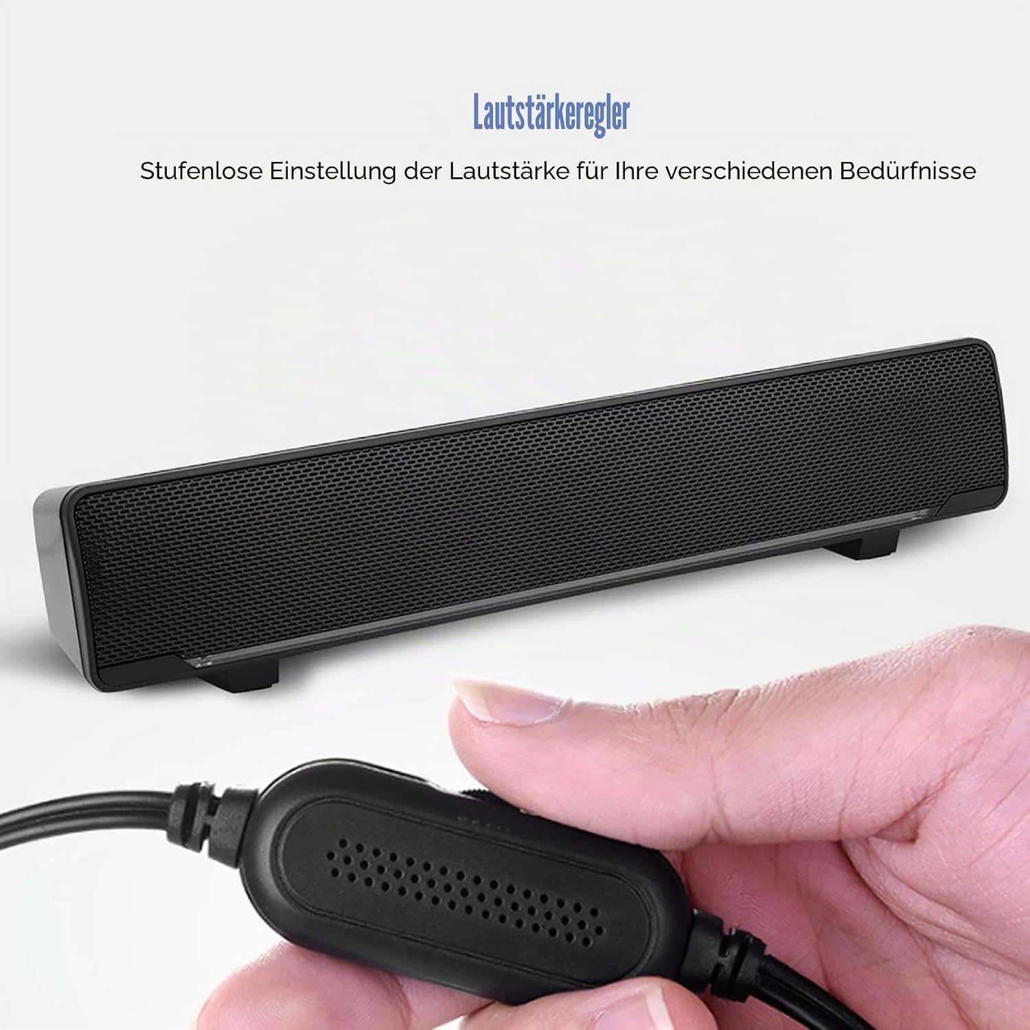 Eine Hand bedient einen schwarzen Lautstärkeregler vor einer grauen Soundbar mit Text darüber.