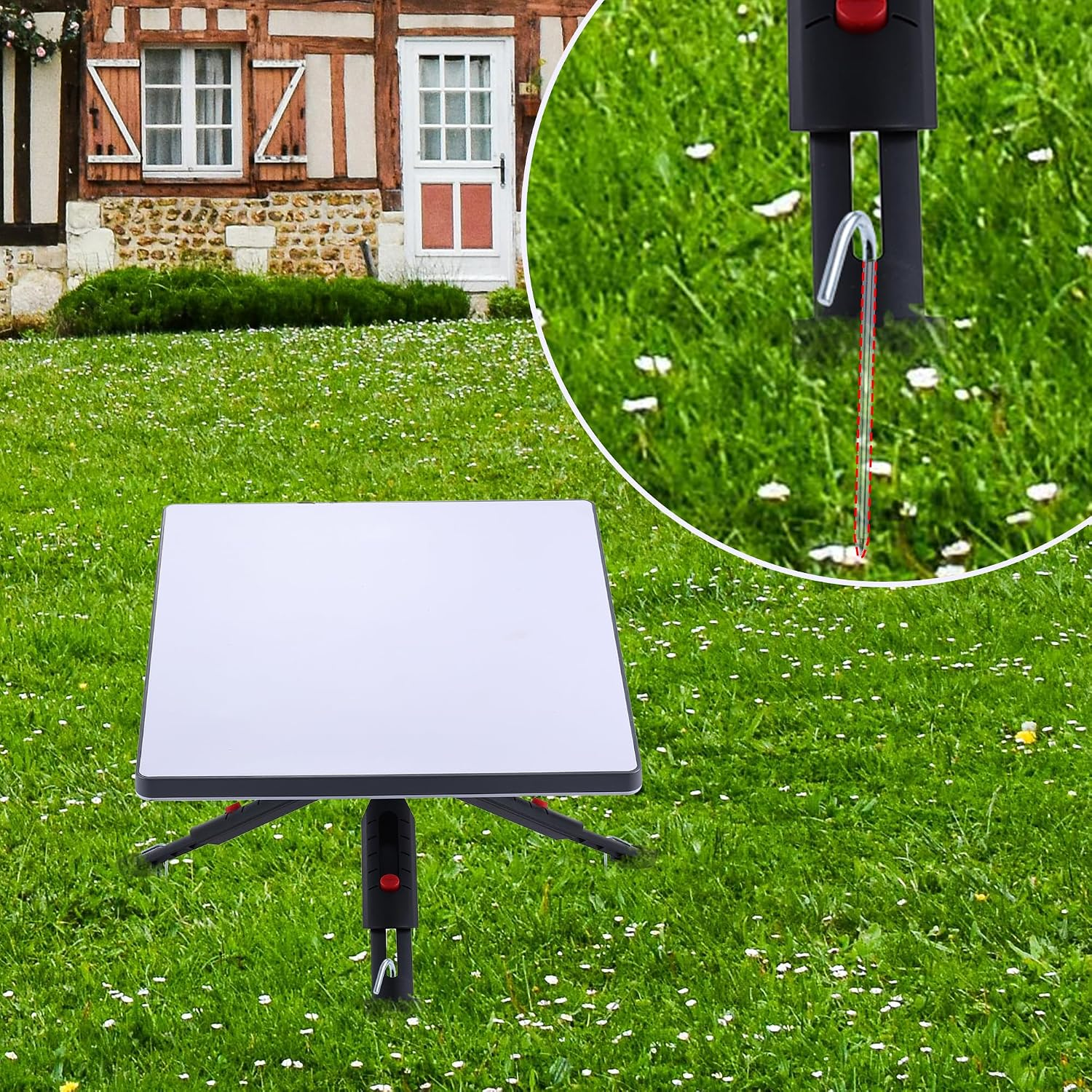 Ein weißer quadratischer Tisch auf grünem Rasen vor einem Fachwerkhaus, mit einer Detailansicht eines Metallherings.