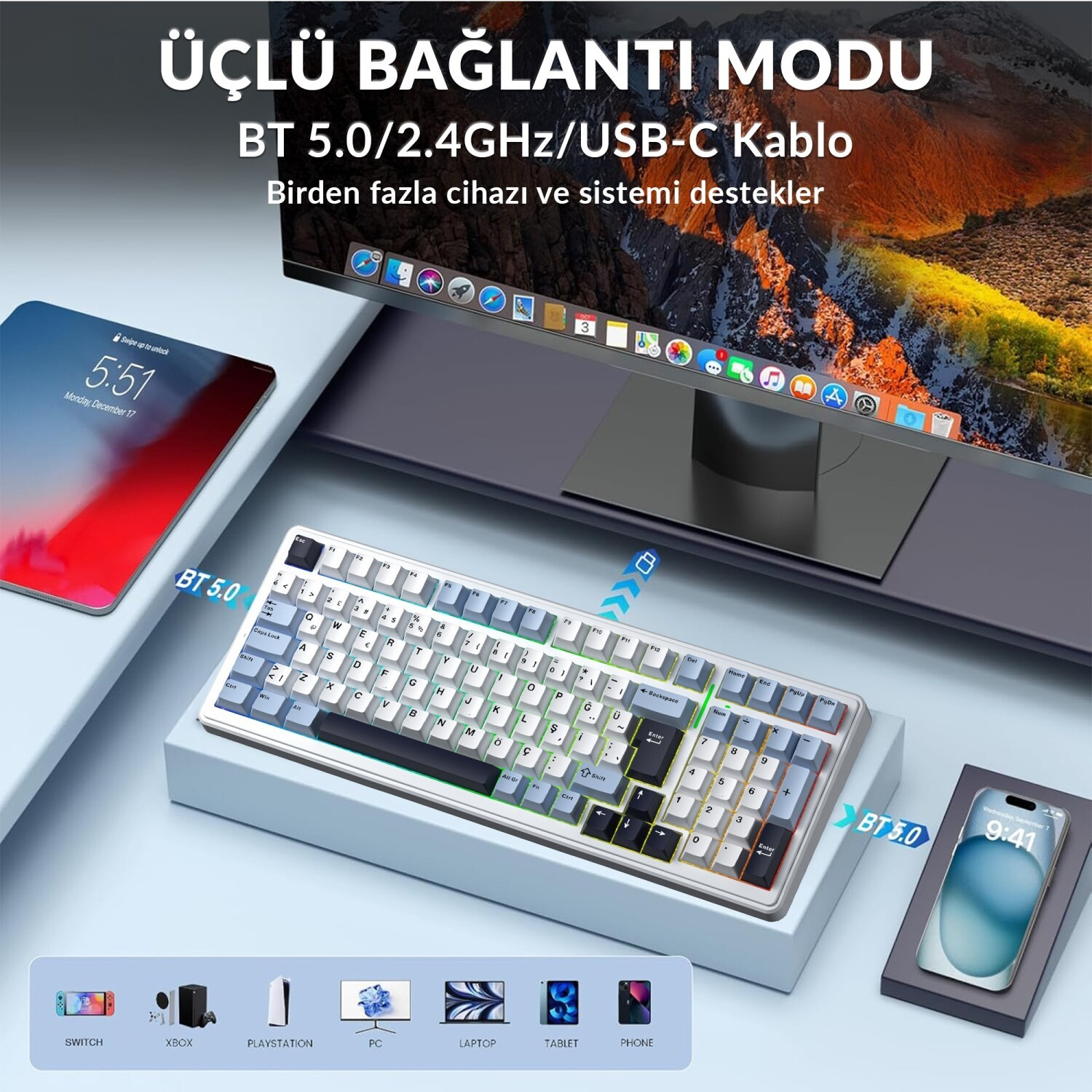 Masaüstünde mekanik klavye, monitör, tablet ve akıllı telefon.
