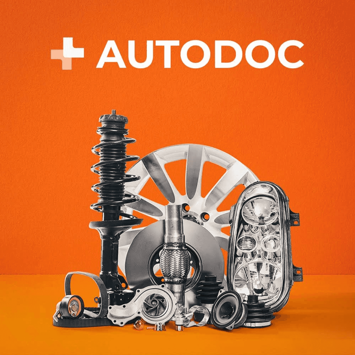 Varias piezas de coche como amortiguador, disco de freno y faro sobre fondo naranja con logo de Autodoc.