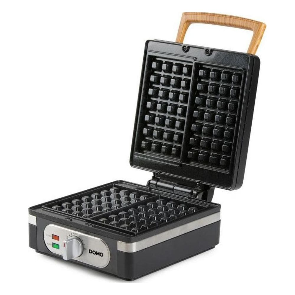 Ein schwarzes Waffeleisen mit geöffnetem Deckel, Holzgriff, silbernem Bedienfeld und Kontrollleuchten auf weißem Grund.