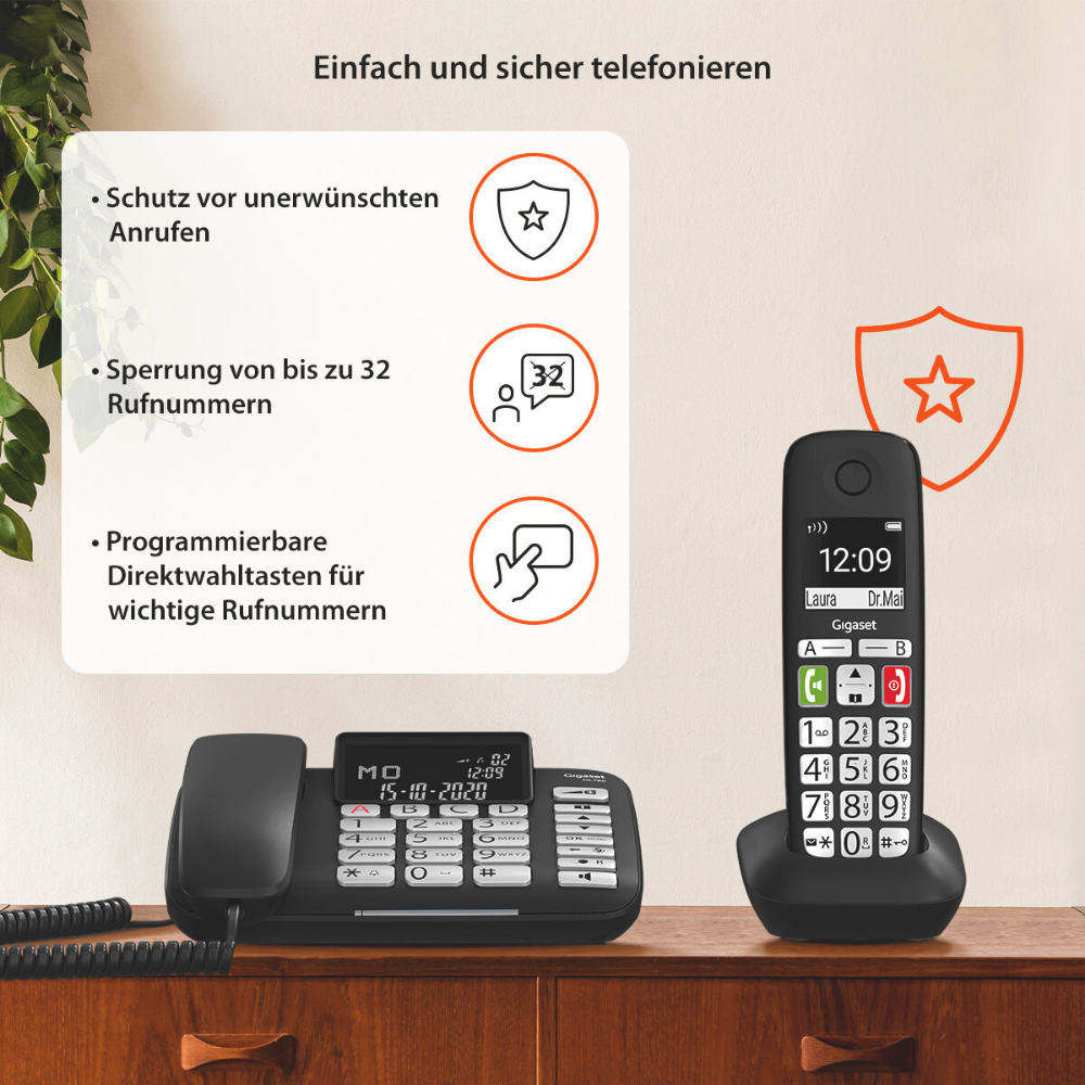 Un telefono Gigaset nero su un mobile in legno con funzioni di protezione.