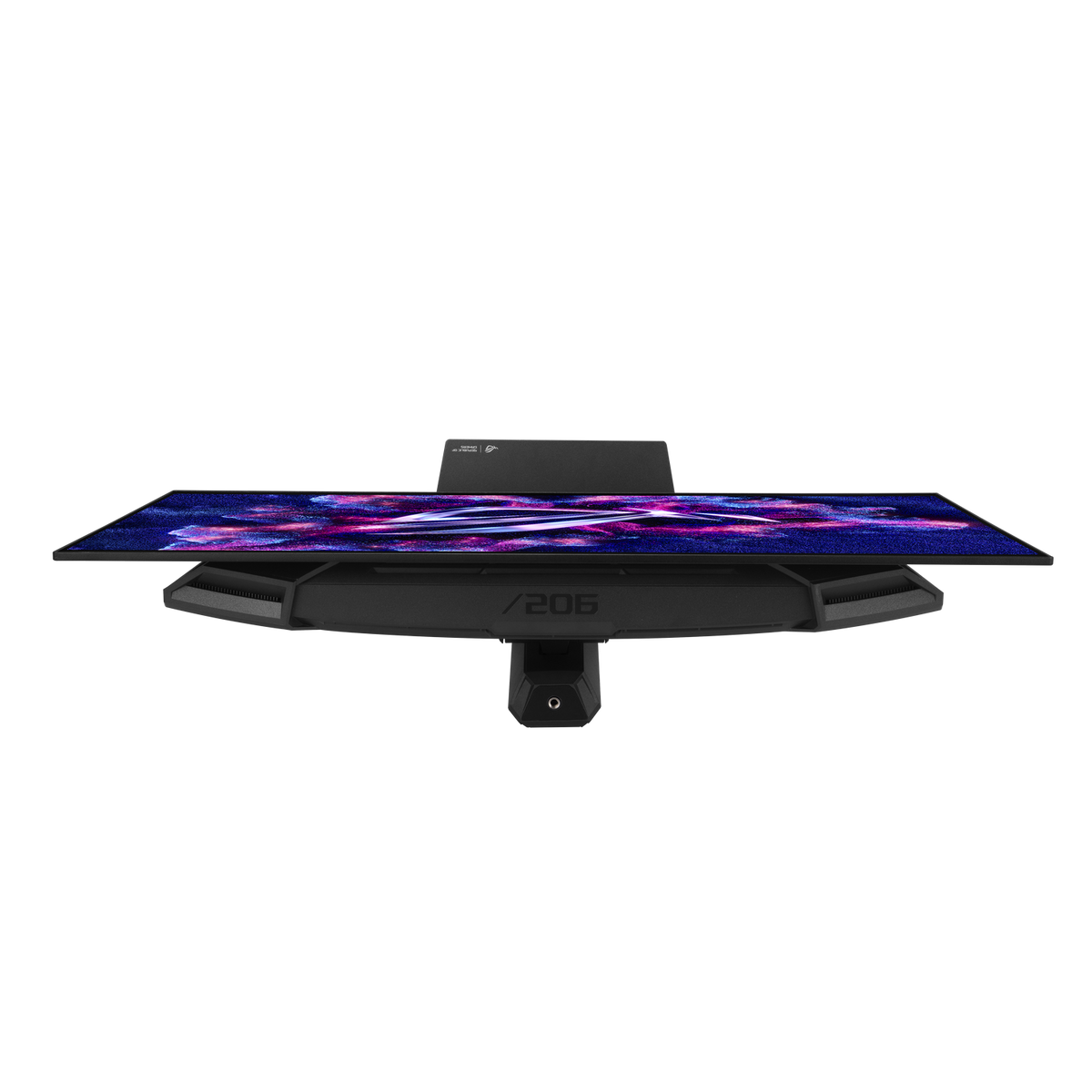Un moniteur de jeu noir affichant un fond d'écran galaxie coloré, vu d'en haut sur fond noir.