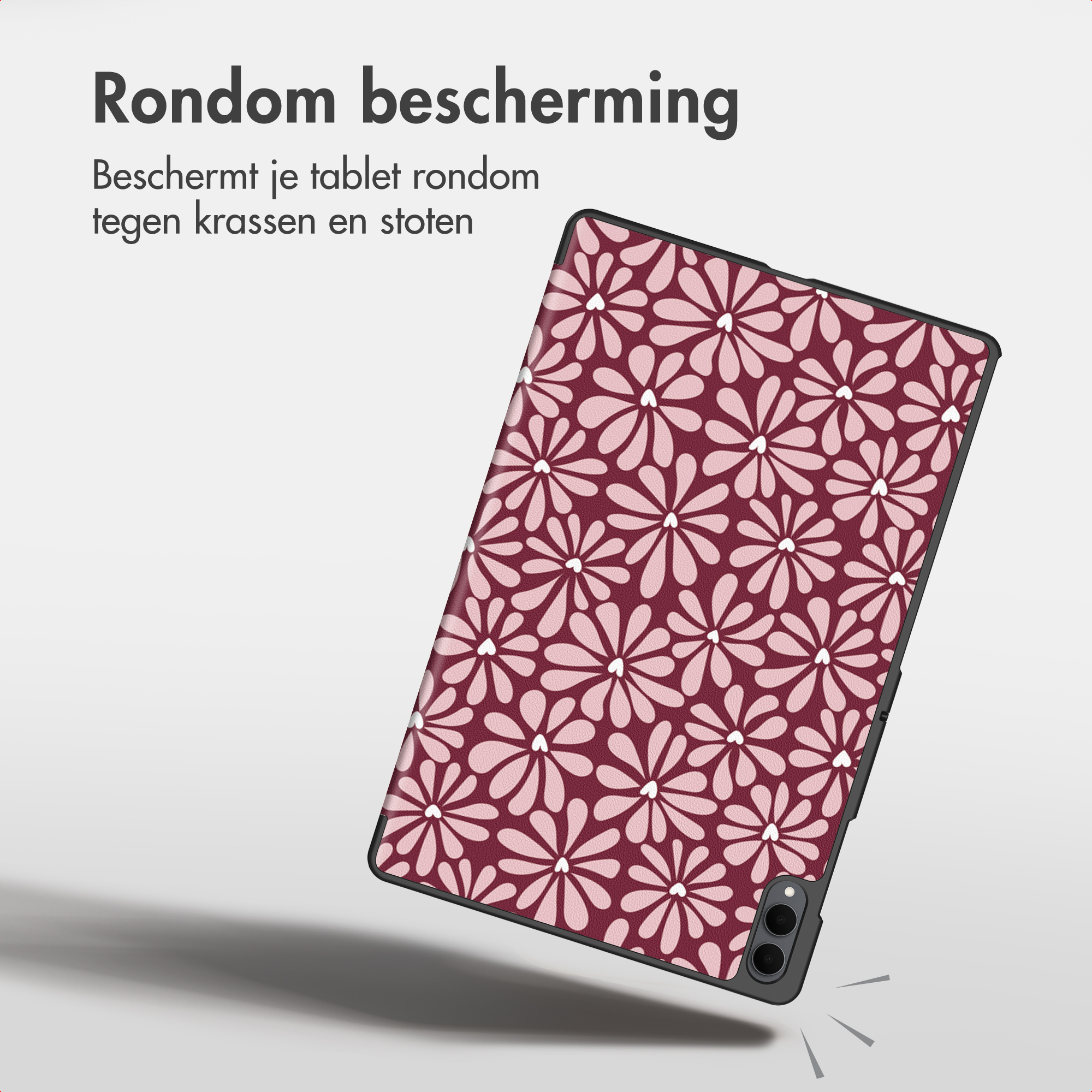 Une tablette dans un étui floral rouge et rose flotte sur fond gris.