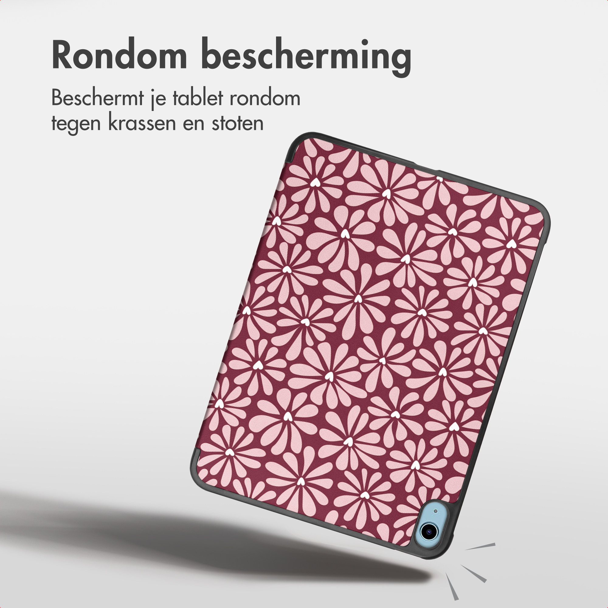 A tablet in a protective case with a red and white floral pattern and text above.