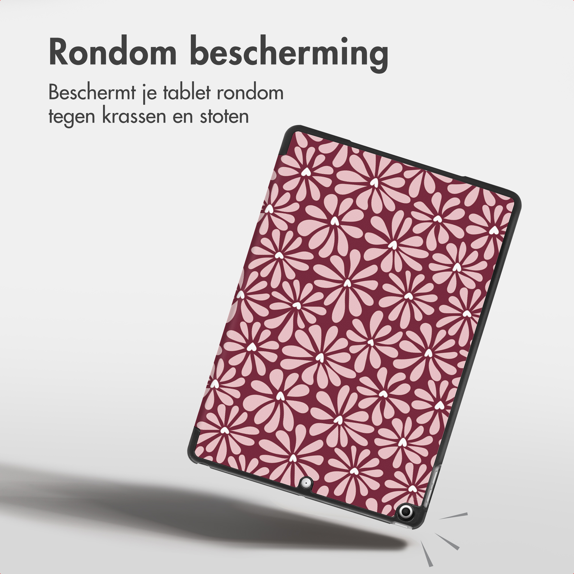 Un tablet con custodia floreale marrone fluttua su sfondo grigio.