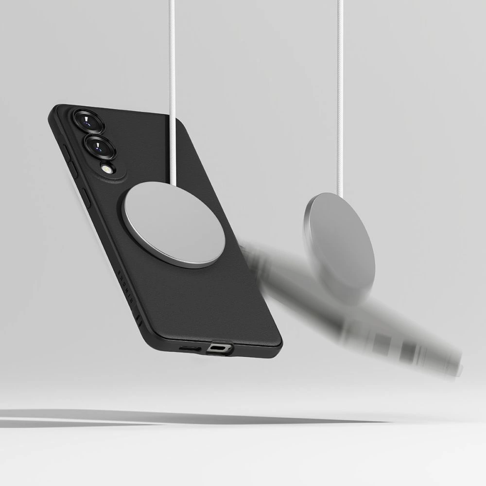 Ein schwarzes Smartphone hängt an einem runden magnetischen Ladeadapter, ein zweiter hängt daneben.