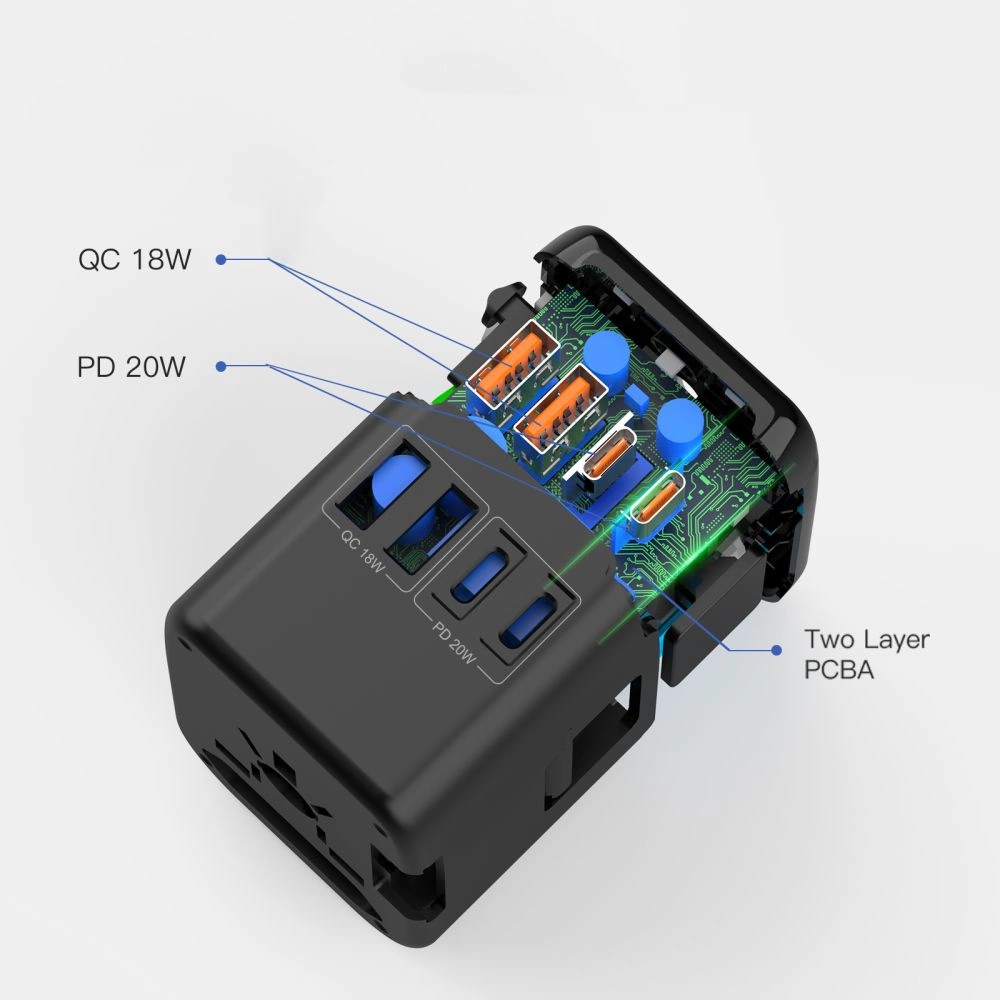 Aufgeschnittener schwarzer USB-Reiseadapter mit sichtbarer grüner Platine und blauen Kondensatoren.
