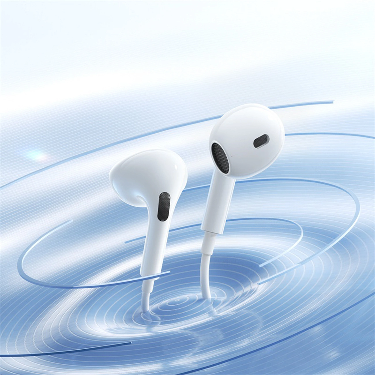 Due auricolari con filo bianchi si trovano su una superficie blu simile all'acqua con onde circolari.