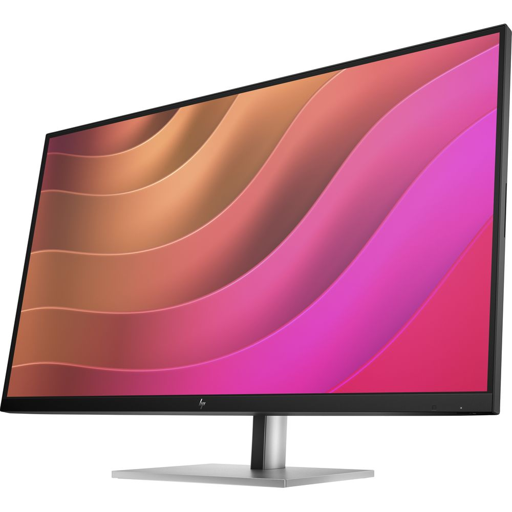 Un monitor nero con supporto argento mostra uno sfondo astratto colorato con sfumature ondulate rosa e arancioni.